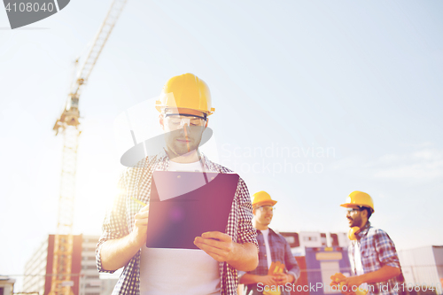 Image of group of builders in hardhats outdoors