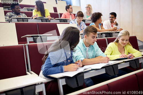 Image of group of students with notebooks at lecture hall