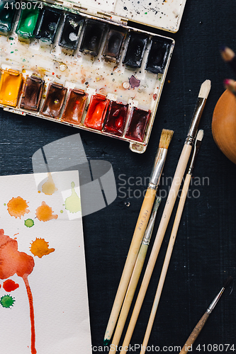 Image of Crop view of watercolor palette and brushes