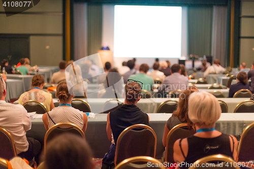 Image of Audience in lecture hall participating at business conference.