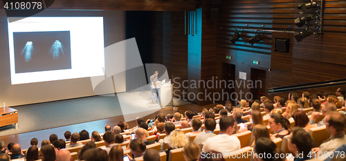 Image of Business speaker giving a talk in conference hall.