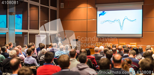 Image of Business speaker giving a talk in conference hall.