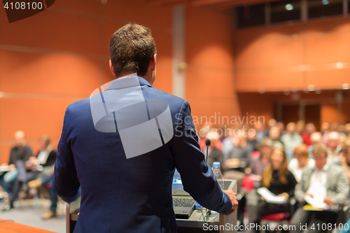 Image of Public speaker giving talk at Business Event.