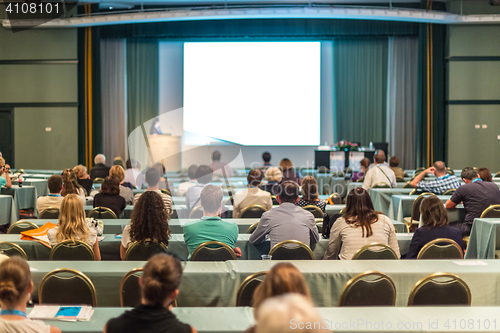 Image of Audience in lecture hall participating at business conference.