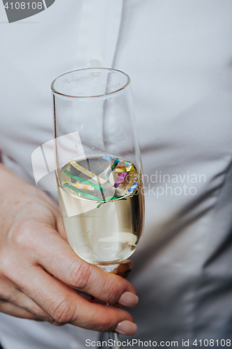 Image of Close up crop hand with wineglass