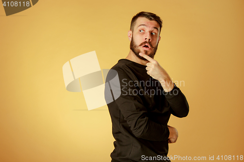 Image of Portrait of young man with shocked facial expression