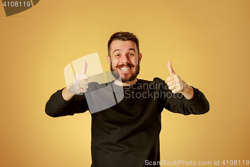 Image of The young happy man looking at camera