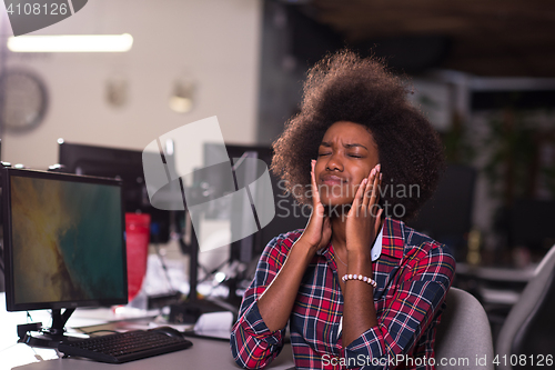 Image of a young African American woman feels tired in the modern office