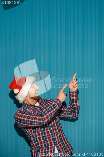 Image of Surprised christmas man wearing a santa hat