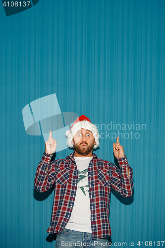 Image of Surprised christmas man wearing a santa hat