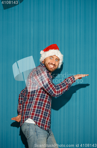 Image of Surprised christmas man wearing a santa hat