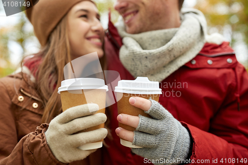 Image of close up of happy couple with coffee in autumn
