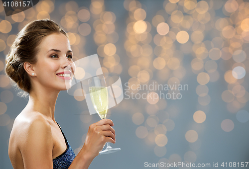 Image of smiling woman holding glass of champagne