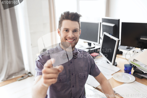 Image of happy male office worker pointing finger at you