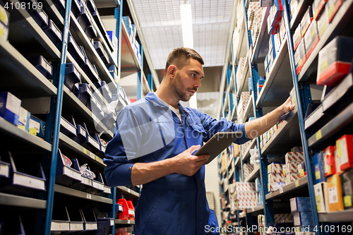 Image of auto mechanic or smith with tablet pc at workshop