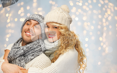 Image of happy family couple in winter clothes hugging