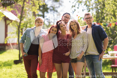 Image of happy teenage friends hugging at summer garden