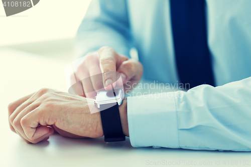 Image of close up of male hands setting smart watch