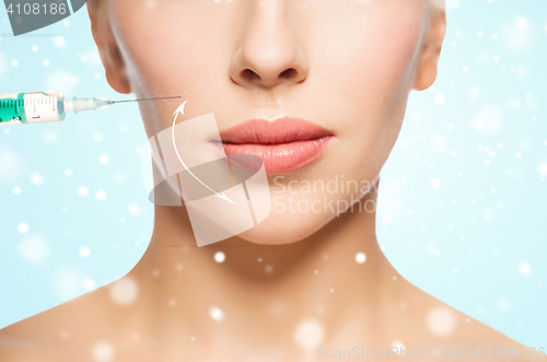 Image of close up of  woman face with arrow and syringe