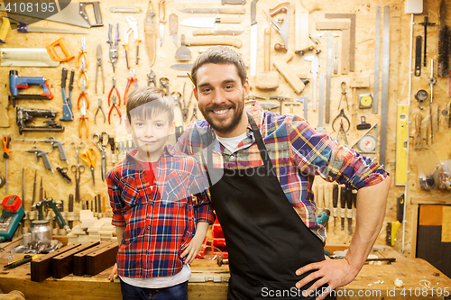 Image of happy father and little son workshop