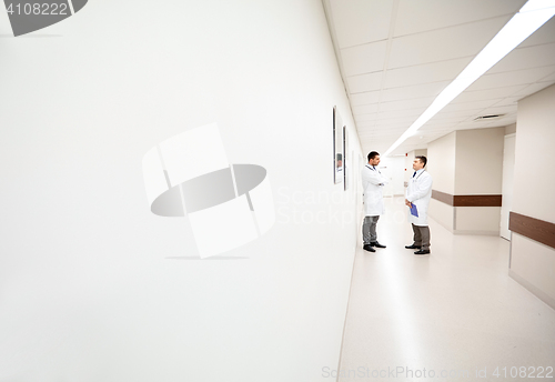 Image of male doctors talking at hospital corridor