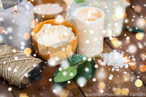 Image of natural body scrub and candles on wood