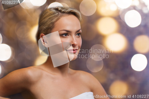 Image of close up of young woman sitting in bath towel