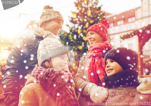 Image of happy family over city christmas tree and snow