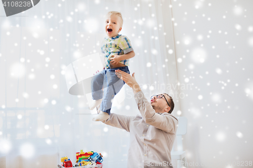 Image of father with son playing and having fun at home