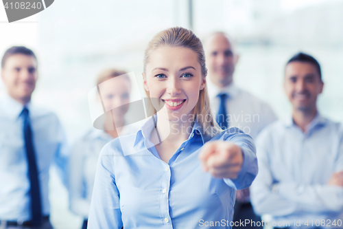 Image of smiling businesswoman pointing finger on you