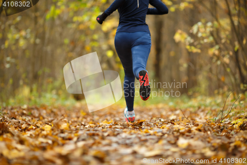 Image of Woman in sportswear running autumn