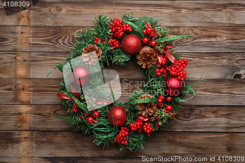 Image of Christmas wreath on wooden background