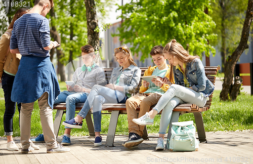 Image of teenage students with tablet pc at school yard