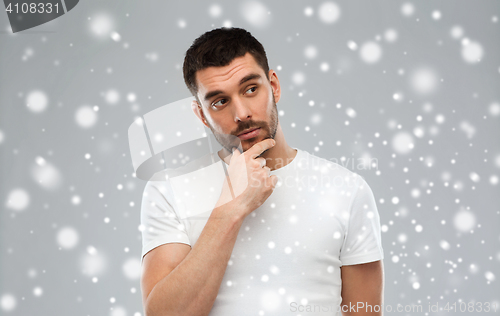 Image of man thinking over snow background
