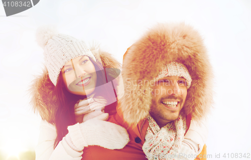 Image of happy couple having fun over winter background