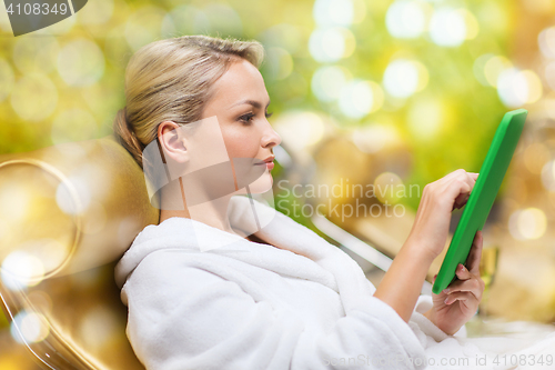 Image of beautiful young woman with tablet pc at spa