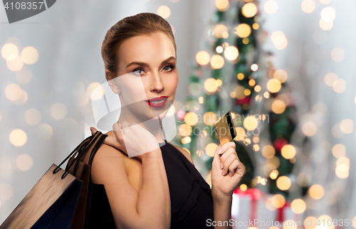 Image of woman with bank card and shopping bags