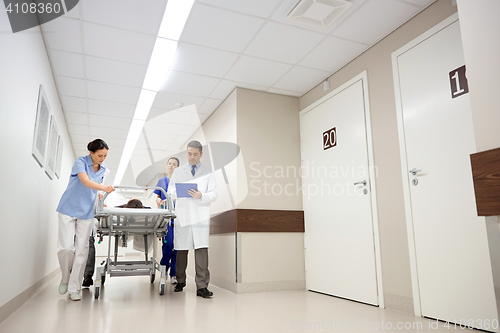 Image of medics and patient on hospital gurney at emergency