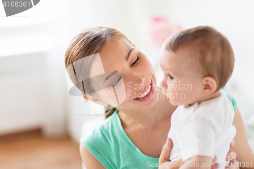 Image of happy young mother with little baby at home