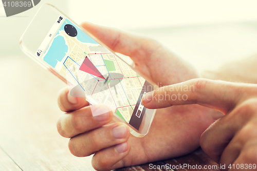 Image of close up of hand with navigator map on smartphone