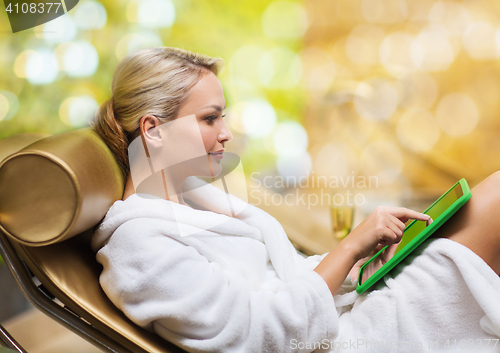 Image of beautiful young woman with tablet pc at spa