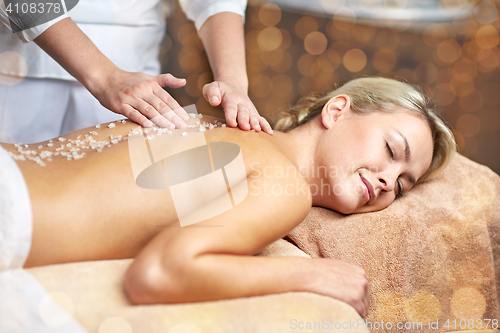 Image of close up of woman lying and having massage in spa