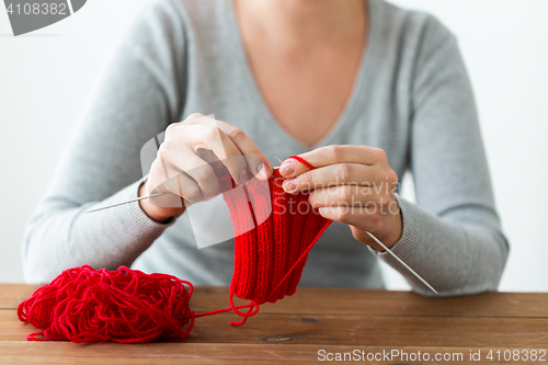 Image of woman hands knitting with needles and yarn