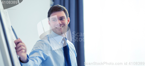 Image of smiling businessman on presentation in office