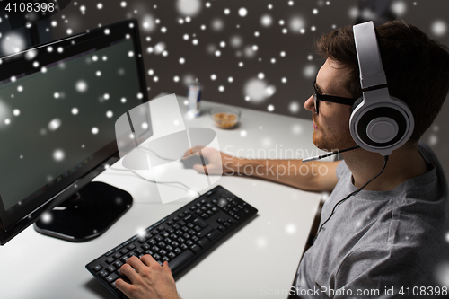 Image of close up of man playing computer video game