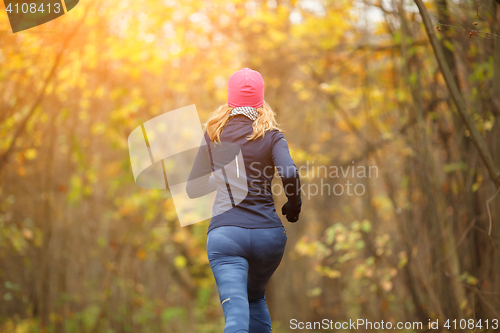 Image of Slender female running in park