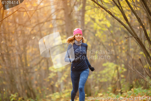 Image of Running on autumn park sportswoman