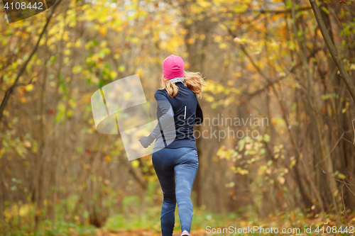 Image of Slender girl running in park