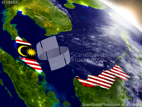 Image of Malaysia with flag in rising sun