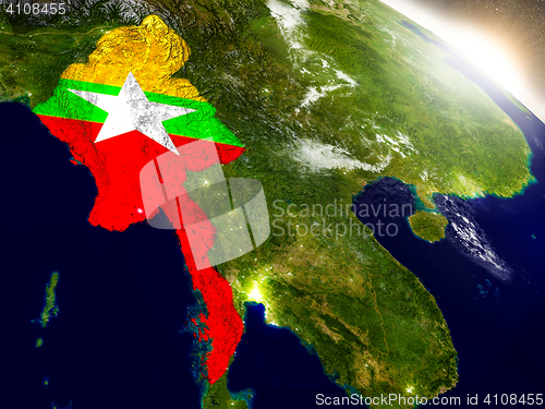 Image of Myanmar with flag in rising sun